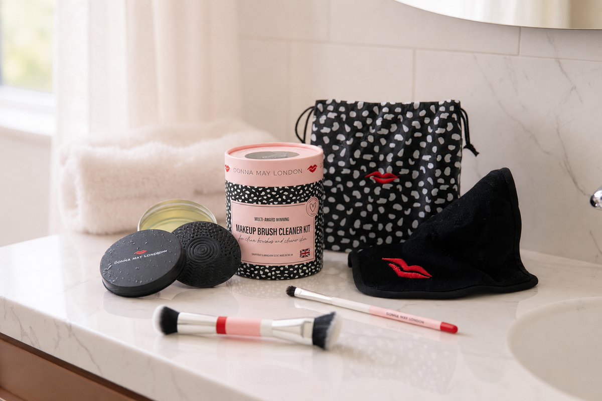 Makeup cleaning kit with brushes and a bag on a bathroom counter