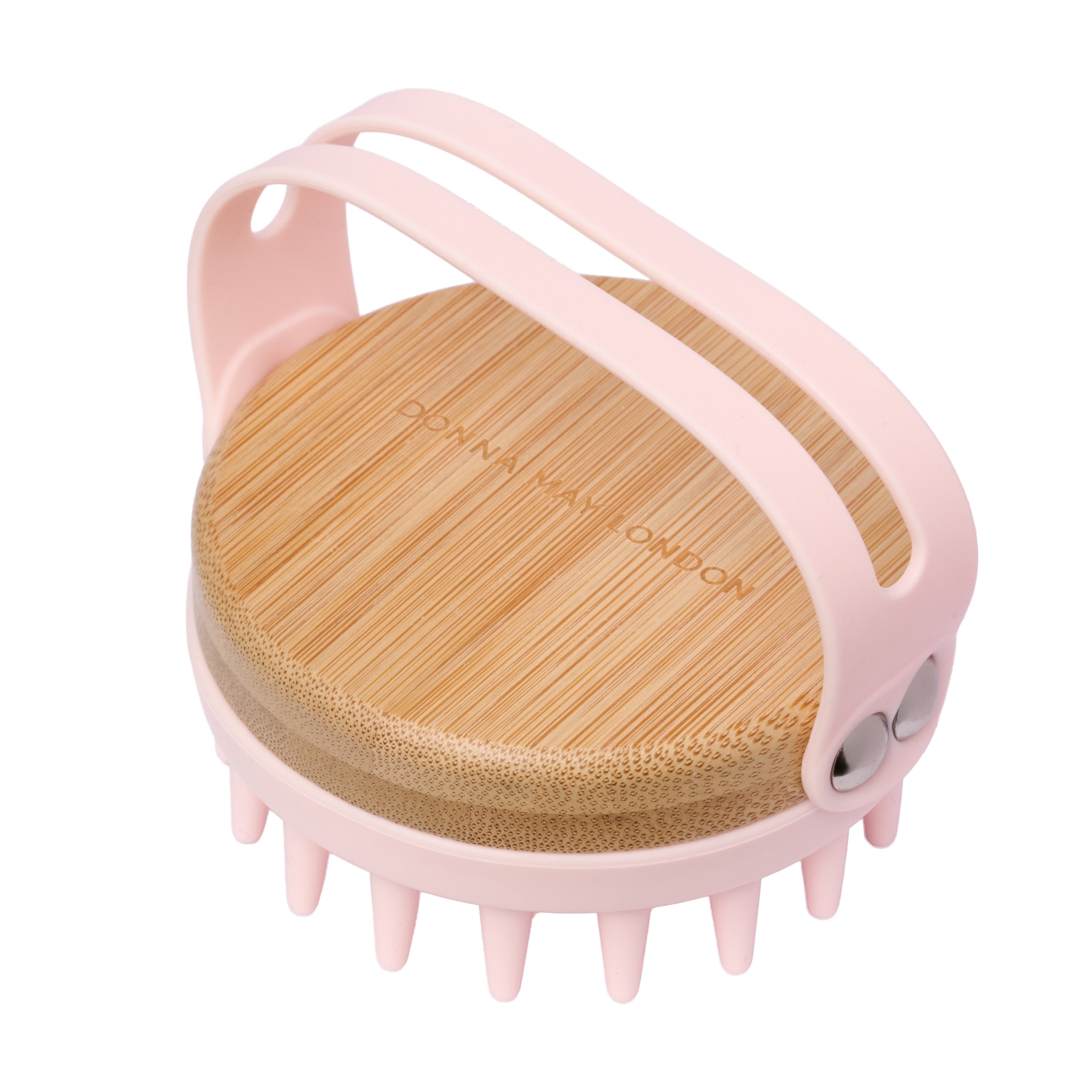 Pink scalp massager with wooden top on a white background