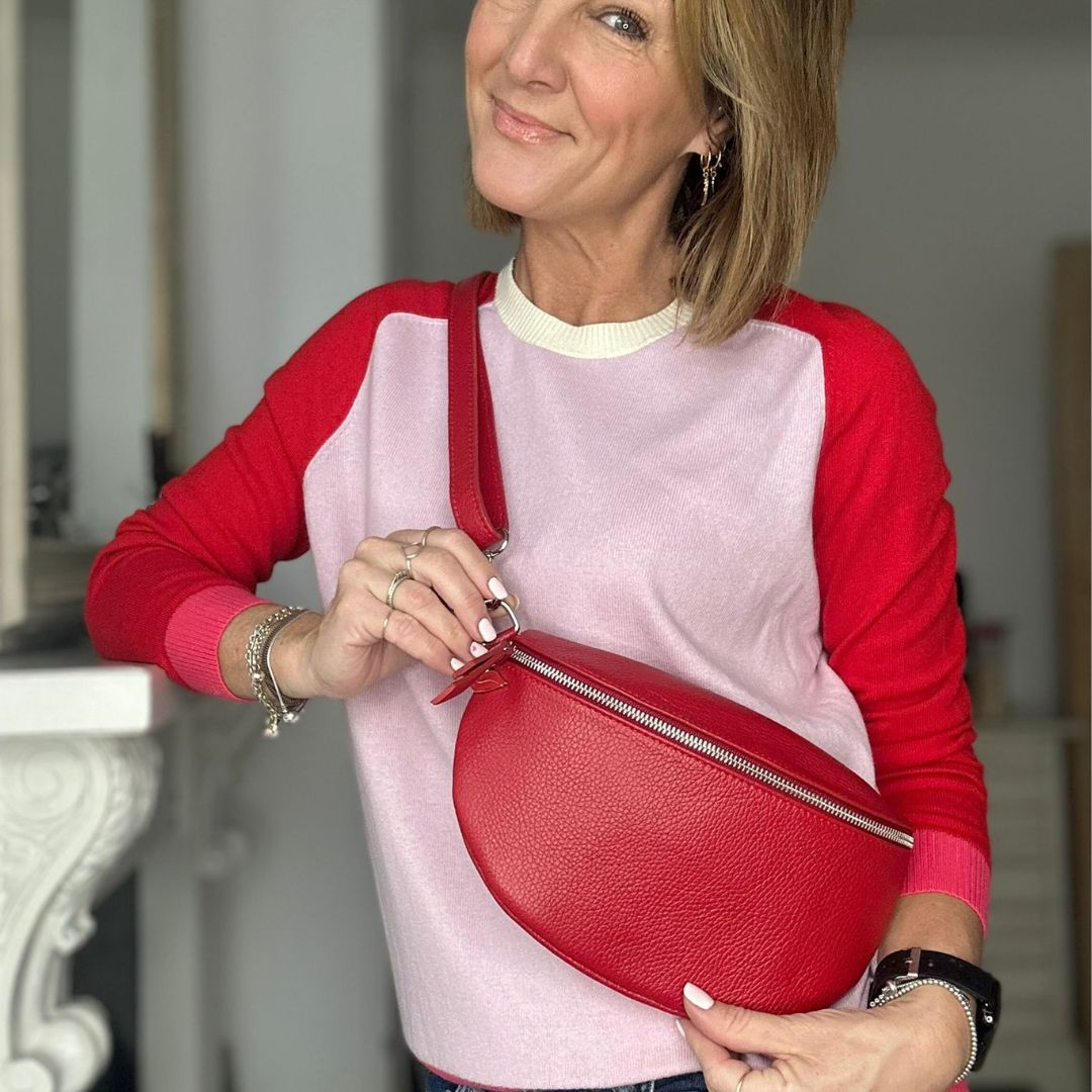 adjustable crossbody leather bag with silver hardware and red lip charm