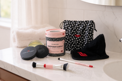 Makeup cleaning kit with brushes and a bag on a bathroom counter