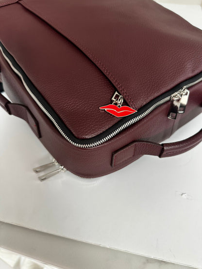 stunning leather rucksack with red lip charm