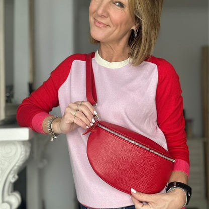 adjustable crossbody leather bag with silver hardware and red lip charm