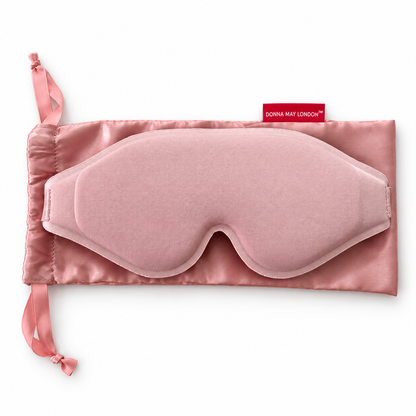 Donna May London blush pink EasySleep mask resting on its matching satin drawstring storage pouch