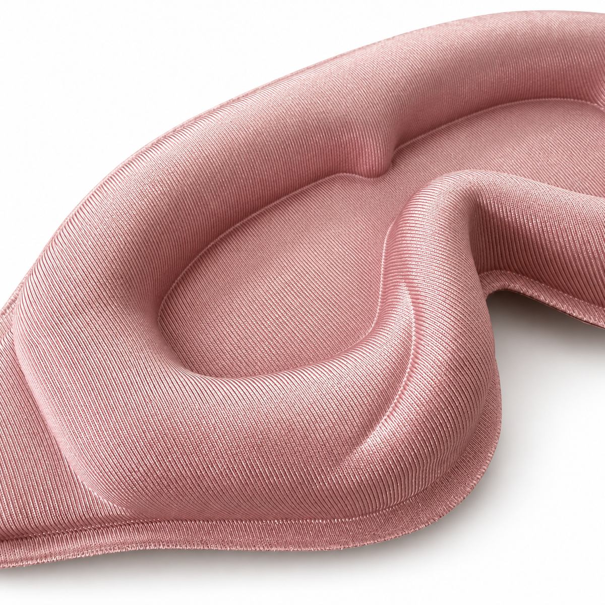 Close-up of the blush pink sleep mask’s recessed eye pocket, soft padding and fine fabric texture