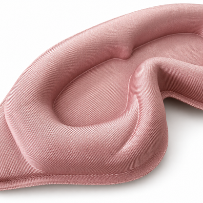 Close-up of the blush pink sleep mask’s recessed eye pocket, soft padding and fine fabric texture