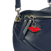 Navy blue handbag with a red lip charm 