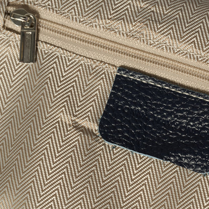 Close-up of a textured beige pouch with a zipper and a black leather cardholder.